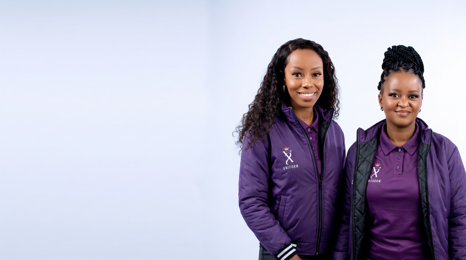 ZS Uniforms co-founders wearing branded ZS Uniform jackets and polo shirts