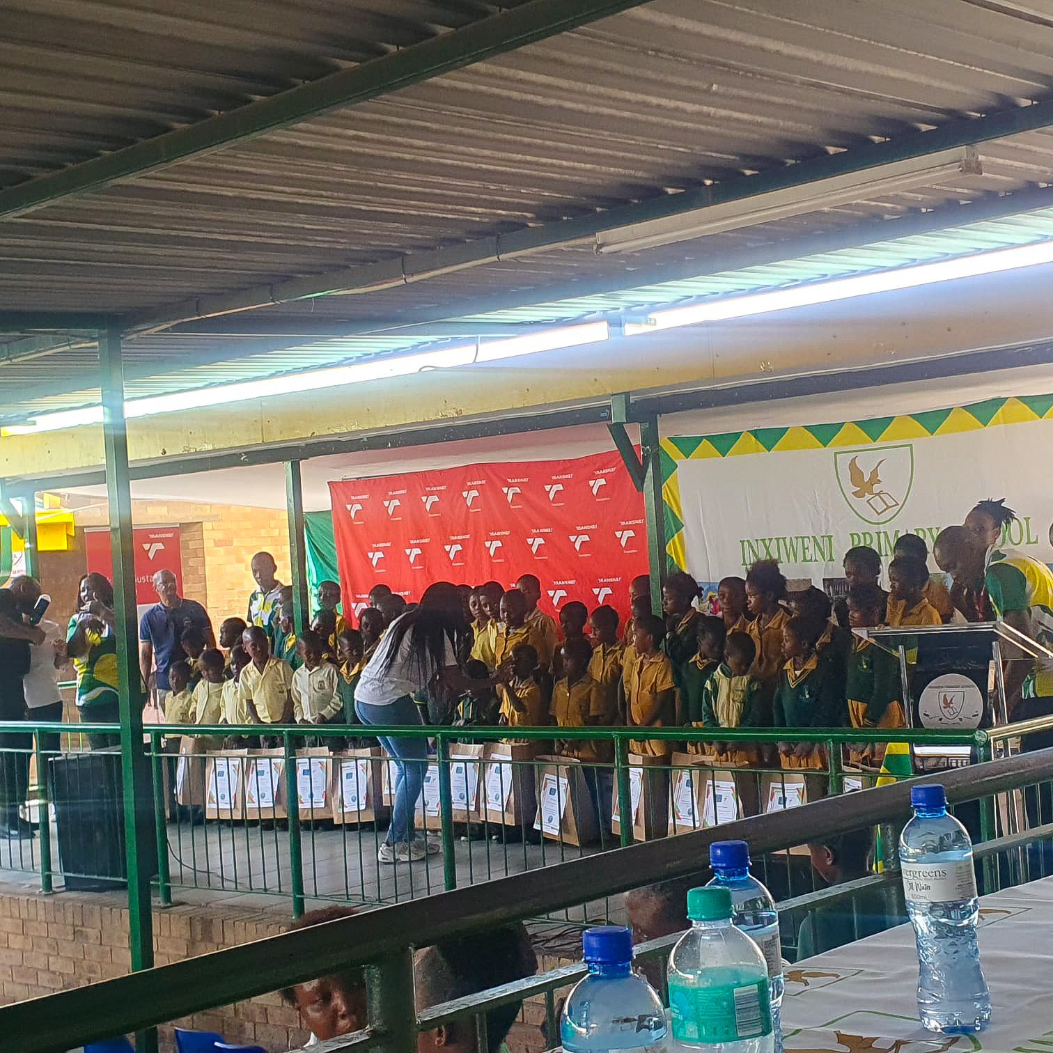 The ceremony at Inxiweni Primary School with the Transnet Foundation backdrop and learners