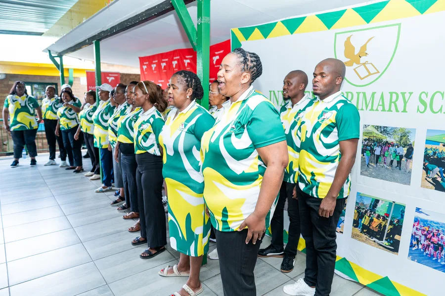 Inxiweni Primary School staff in school colours lined up at the handover ceremony