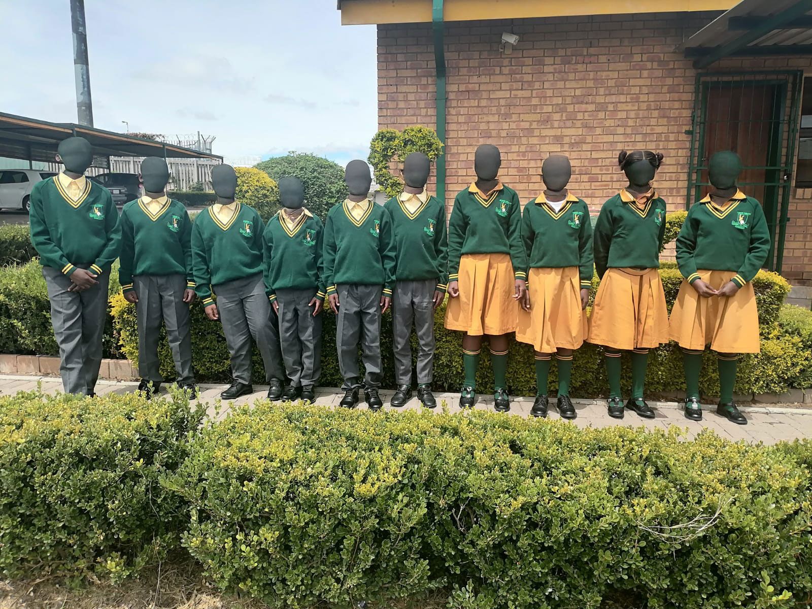 Recipients of the school uniform handover at Inxiweni Primary School proudly wearing their new full uniforms