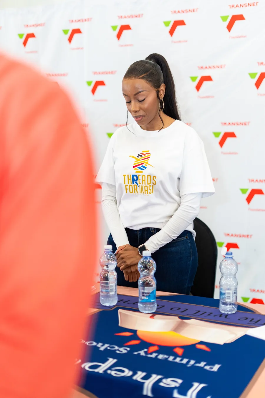 A Threads for iKasi Foundation representative at the Tshepisa Primary School banner during the handover